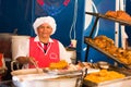 QUITO, ECUADOR- 07 MAY, 2017: Close up of an unidentified woman preparing hornado roasted pork ecuadorian traditional