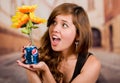 Quito, Ecuador - May 06, 2017: Pretty young woman holding a pepsi with sunflowers inside in blurred city background