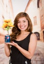 Quito, Ecuador - May 06, 2017: Pretty young woman holding a pepsi with sunflowers inside in blurred city background