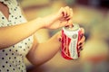 Quito, Ecuador - May 06, 2017: Young woman opening a refreshing Budweiser beer in a blurred background, vintage effect