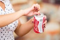 Quito, Ecuador - May 06, 2017: Young woman opening a refreshing Budweiser beer in a blurred background, vintage effect