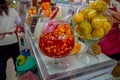 QUITO, ECUADOR - NOVEMBER 23, 2016: Fruit salad and orange fruits inside of a big glass cup, at the municipal market Royalty Free Stock Photo