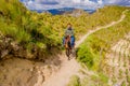 QUITO, ECUADOR - NOVEMBER, 25 2016: Unidentified young tourist riding a horse trought a sandy path near Quilotoa