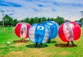 QUITO, ECUADOR - NOVEMBER 28, 2017: Young people playing soccer while is inside of giant inflatable balls in the