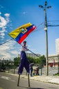 QUITO, ECUADOR - OCTOBER 23, 2017: Close up of young school student holding a ecuadorian flag in his hands and waking