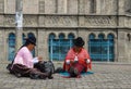 Quito, Ecuador: Two women sewing in the street, practicing their handmade jobs, with traditional Andean clothing