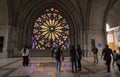 Tourists taking photos in front of the rosette window inside the Basilica of the National Vow