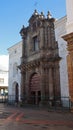 Woman sitting at the door of Church of Saint Augustine is a historic 16th century structure located in the historic center of