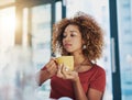 Quitters make excuses, winners make coffee. a young businesswoman having coffee at her desk.