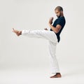 Quitters never win and winners never quit. Studio shot of a young martial artist practicing.