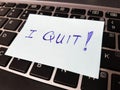 Quitting a job concept using a sticky pad with the word `I QUIT!` written on it and left on top of a keyboard