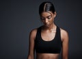 Quitting is an option only chosen by the weak. Studio shot of a focused young sportswoman posing with her head down