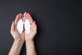 Quitting smoking concept. Woman holding paper lungs on black background, top view and space for text