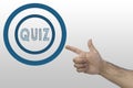 Quiz concept. Male`s hand pointing to a circle with text: Quiz