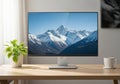 Computer monitor displaying a snowy mountain landscape on a desk Royalty Free Stock Photo
