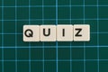 Quiz word made of square letter word on green square mat background
