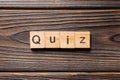 Quiz word written on wood block. Quiz text on wooden table for your desing, Top view concept Royalty Free Stock Photo