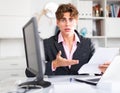 quizzical man working on his laptop in white room Royalty Free Stock Photo