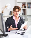 quizzical man working on his laptop in white room Royalty Free Stock Photo