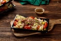 Qunioa salad with beans, tomato, cucumber and sauce served in a dish isolated on wooden table background side view of salad