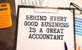 Quote Behind Every Good Business Is A Great Accountant handwritten on notebook page next to calculator and pen