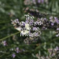 Quote The Wretched Have No Friends. On A Blurry Floral Background