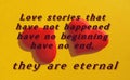 Quote on yellow background with red hearts     Love stories that have not happened have no beginning have no end, they are eternal Royalty Free Stock Photo