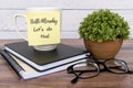 Quotes - Hello Monday, let`s do this text on sticky note on top of table