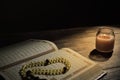 The Qur`an, the holy book of Islam. worship month of Ramadan, reading the scriptures by using a candle light. Royalty Free Stock Photo