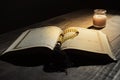 The Qur`an, the holy book of Islam. worship month of Ramadan, reading the scriptures by using a candle light. Royalty Free Stock Photo