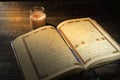 The Qur`an, the holy book of Islam. worship month of Ramadan, reading the scriptures by using a candle light. Royalty Free Stock Photo