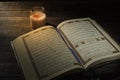 The Qur`an, the holy book of Islam. worship month of Ramadan, reading the scriptures by using a candle light. Royalty Free Stock Photo