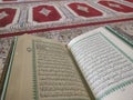 Quran on elegant Persian rugs - the Arabic text with English translation. Royalty Free Stock Photo