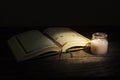 The Qur`an, the holy book of Islam. worship month of Ramadan, reading the scriptures by using a candle light. Royalty Free Stock Photo