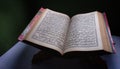 Quran-holy book of Muslims, an open book on rehal or wooden book Royalty Free Stock Photo