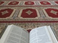 Quran on elegant Persian rugs - the Arabic text with English translation. Royalty Free Stock Photo