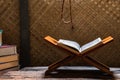 Quran on rihal or wooden book stand and misbaha or islamic prayer beads