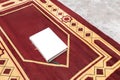 Quran and special mat for prayer and namaz. Concept of the religion of Islam