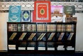 Quran text books inside a wooden bookshelf in different sizes, translation of Arabic text (The noble Quran)