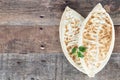 Qutab, kutab with green on a wooden background. Azerbaijani flat bread with greens. Top view, copy space.
