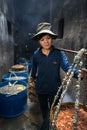 Quy Nhon, Vietnam - Oct 22, 2016: Seafood processing at fish market in Quy Nhon, south Vietnam. A woman carry baskets of boiled se