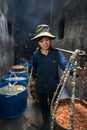 Quy Nhon, Vietnam - Oct 22, 2016: Seafood processing at fish market in Quy Nhon, south Vietnam. A woman carry baskets of boiled se