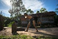 Quy Nhon, Vietnam - Oct 22, 2016: Strong old man splitting wood with an axe in the countryside in Quy Nhon