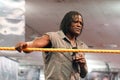R Truth talks into mic holding rope
