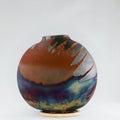 RAAQUU raku fired pottery globe vase Royalty Free Stock Photo