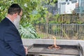 Rabbi Burning Chametz foods on the morning before Passover Jewish holiday