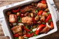 Rabbit baked with mushrooms, sweet pepper and onions macro in a Royalty Free Stock Photo