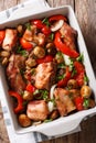 Rabbit baked with mushrooms, sweet pepper and onions macro in a Royalty Free Stock Photo