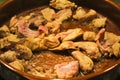 Rabbit and chicken meat frying in a clay pot Royalty Free Stock Photo