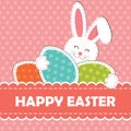 A rabbit with a curved ear holds an egg in its hands and a welcoming text on a rosy background. Greeting card for easter Royalty Free Stock Photo